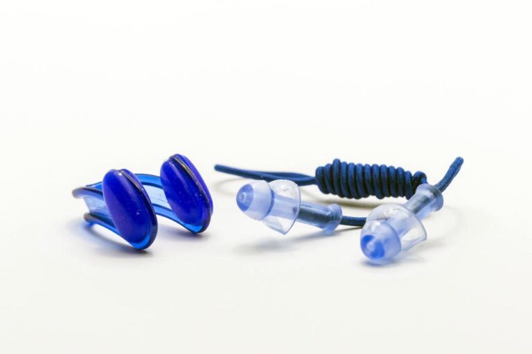 Nose clip and ear plugs for swimming pool on white background. Sport equipment, blue
